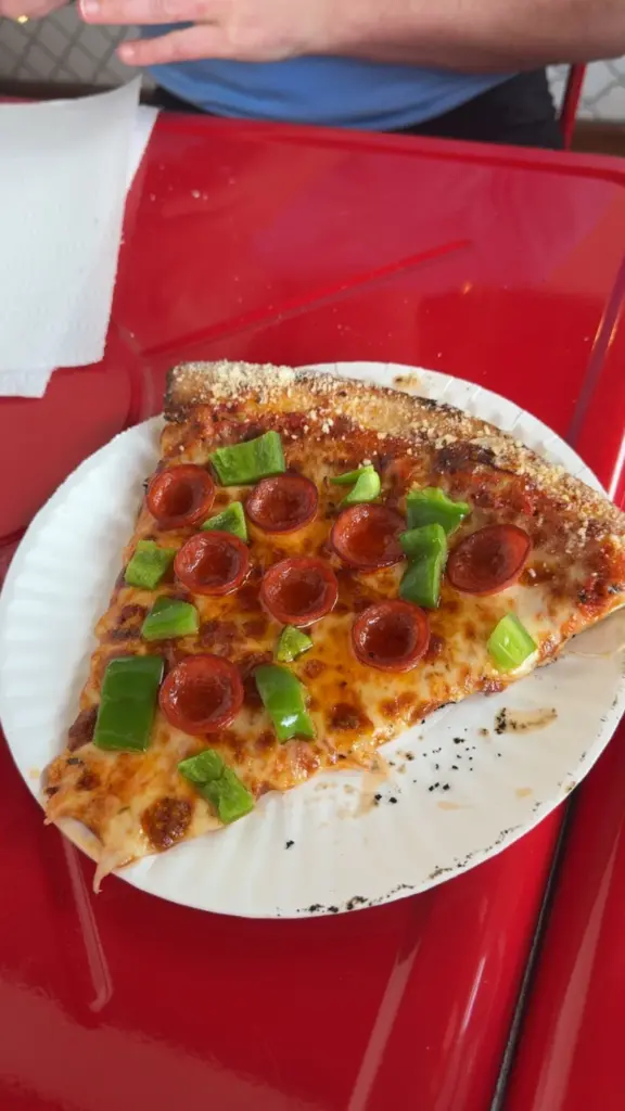 Pepperoni pizza slice with toppings at Marmadukes Lodge
