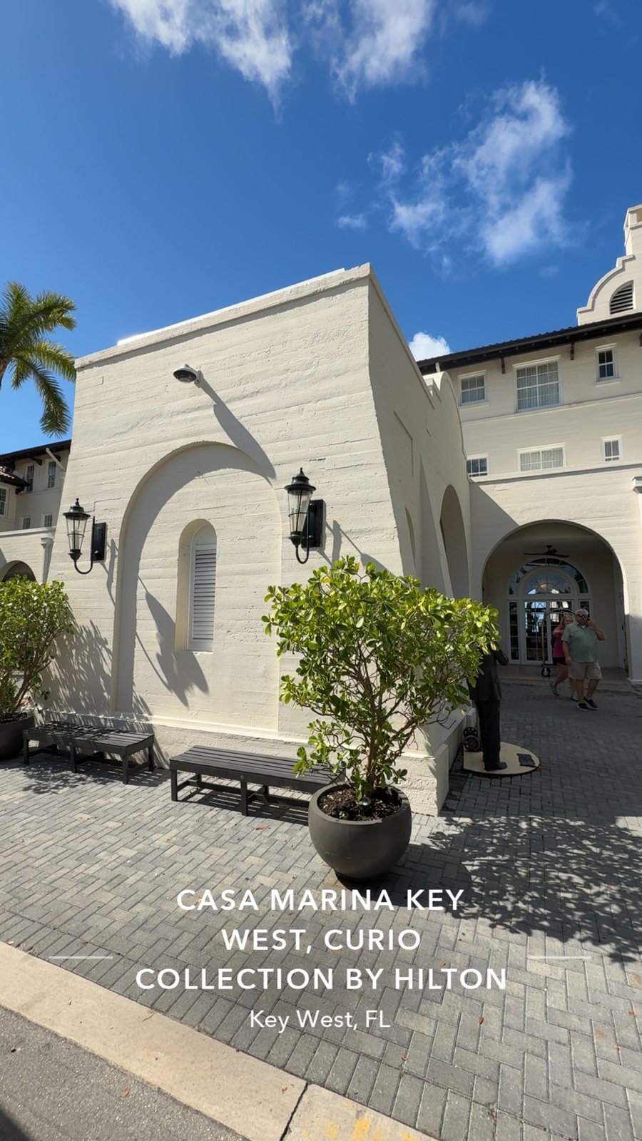 Entrance to Casa Marina Key West with palm trees and an arched doorway.