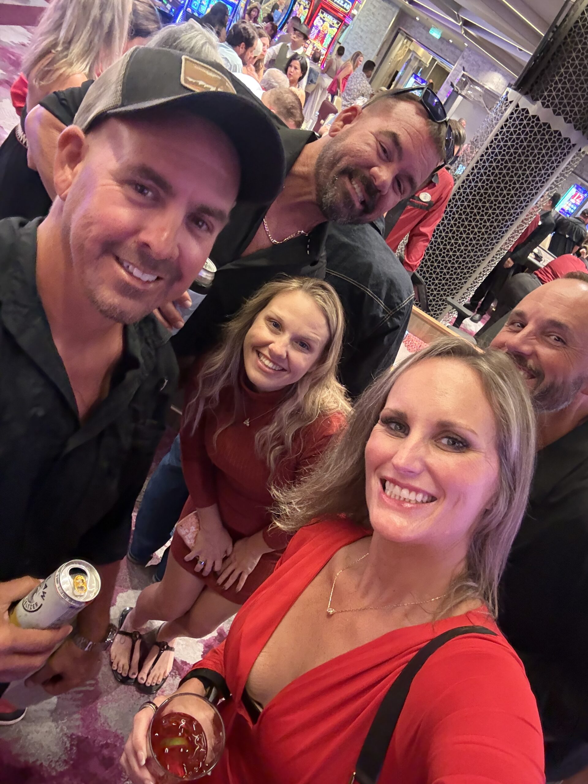 Five friends smiling for a selfie inside the casino aboard Utopia of the Seas