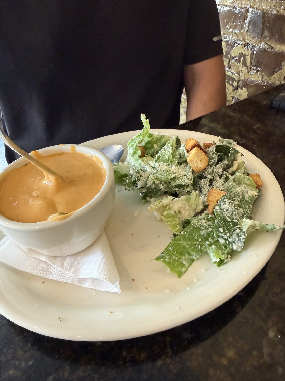 Salad with croutons and grated cheese served beside a bowl of beer cheese soup at McCracken’s Pub in Leesburg.